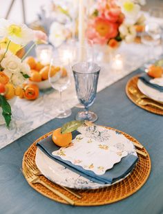 the table is set with plates and place settings