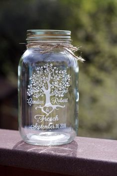 a mason jar with a tree etched on it