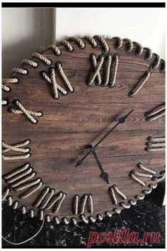 a large clock made out of rope and wood