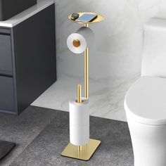 a bathroom with a toilet, sink and phone holder