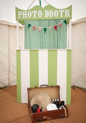 an open suitcase sitting in front of a photo booth