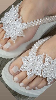 Celebrate the chic resort wedding with our white wedding embroidered sandal, a handmade gift perfect for beach weddings. This embroidered bridal flip flop, adorned with faux pearls, adds an elegant touch to the bride's ensemble. **For more gift options take a look at our best seller flip flops https://designbydesirenyc.etsy.com/listing/1304420049 PRODUCT DETAILS  - Rubber flip flop sole - Origin: imported from Brazil  - Platform height: 3/4" - Thinner straps  - Satin silk cord (very pleasant to Elegant White Beaded Sandals, Traditional Summer Wedding Shoes, White Beaded Adjustable Bridal Accessories, Adjustable Beaded White Bridal Accessories, White Pearl Embellished Wedding Shoes For Summer, Elegant White Wedding Shoes For Beach Ceremony, Handmade White Sandals For Wedding, White Beaded Sandals For Beach, Handmade White Wedding Sandals