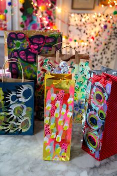 brightly colored paper bags are lined up on the table