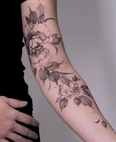 a woman with a flower tattoo on her arm