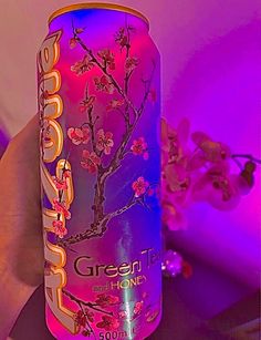 a pink and purple can with flowers on it