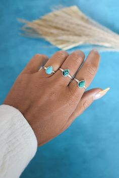 Dainty stackable turquoise ring set in 925 sterling silver. Wear this ring on its own or pair it with others. Add the 'Sole Ring' for a gorgeous sun inspired stacked look as shown in the photos! This listing is for ONE turquoise ring. Photos and videos with more than one are to show variation and stacking options. If you like the stacked option shown in the photos, please purchase the 'Sole Ring' to complete the look! 925 Sterling Silver Natural, Genuine Turquoise Stone Size 6mm x 9mm‍ Nickel Fr Dainty Sterling Silver Turquoise Ring, Minimalist Silver Stackable Turquoise Ring, Affordable Nickel-free Silver Turquoise Ring, Cheap Nickel-free Silver Turquoise Ring, Adjustable Silver Turquoise Multi-stone Ring, Stacker Rings, Ring Turquoise, Turquoise Ring Silver, Turquoise Rings