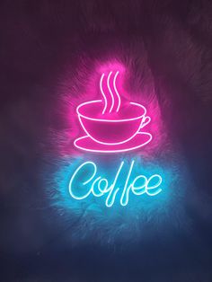 a neon sign that says coffee with a cup on it in front of a dark background