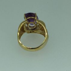 "This fashionable large 14kt Yellow Gold Oval Amethyst Ring consisting of 1- 14mm x 10mm, 5.76ct total weight fine genuine oval Amethyst is 4 prong set in a heavy mounting with design work on both sides in highly bright polished. The overall width is 16mm or 5/8\". The finger size is 8 1/2 and can be resized for an additional $95.00 upon request. This item would Retail for $890.00" Luxury Yellow Gold Amethyst Ring With Prong Setting, 14k Gold Polished Amethyst Ring, 14k Gold Amethyst Ring With Polished Finish, 14k Gold Round Amethyst Ring With Polished Finish, Oval Amethyst Ring In Luxury Style, Oval Amethyst Ring In Yellow Gold With Polished Finish, Oval Yellow Gold Amethyst Ring With Polished Finish, Luxury Gold Amethyst Ring With Center Stone, Luxury Oval Amethyst Ring With Polished Finish