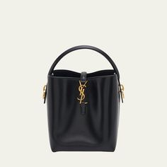 Saint Laurent "Le 37" bucket bag in leather  Flat top handle  Open top with center YSL strap closure  Bronze hardware. Interior, one slip pocket  Feet protect bottom of bag  Approx. 6.7"H x 9.1"W x 3.5"D Made in Italy High-end Bucket Bag With Top Carry Handle, Designer Bucket Bag With Detachable Strap, High-end Double Handle Bucket Bag, High-end Bucket Bag With Detachable Handle For Everyday, High-end Daily Use Bucket Bag With Gold-tone Hardware, High-end Crossbody Bucket Bag With Detachable Handle, Evening Bucket Bag With Gold-tone Hardware And Top Handle, Formal Bucket Bag With Gold-tone Hardware, High-end Shopping Bucket Bag With Gold-tone Hardware