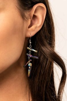 a close up of a person wearing some kind of earrings