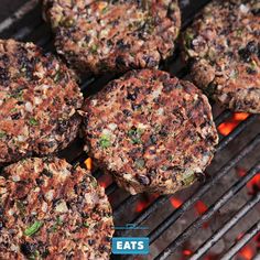 hamburger patties cooking on the grill with flames