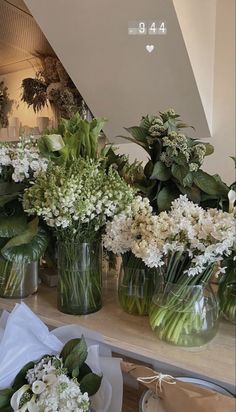 several vases filled with white flowers on a table