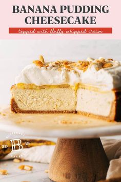 banana pudding cheesecake with whipped cream and toasted almonds on the side, sitting on a cake stand