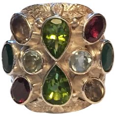 Pears shape Peridot. Oval Garnet, Round aquamarine, Oval Smokey Topaz, and oval Emerald are hand cut and polished . All the stones are natural not heated or treated stones. Hand crafted one of a kind ring IS UNISEX. Total weight is 19.01 Gram. Now 8.5 is size of the ring but can be resized. Christmas Photo Album, Smokey Topaz, Handcrafted Rings, Color Stone, Cocktail Rings, Christmas Photos, Pear Shaped, Aquamarine, Stone Color