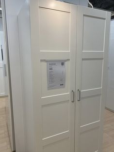 two white doors with price tags on them in an office building or showroom area