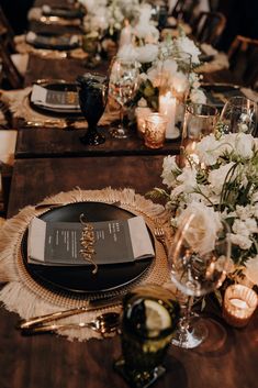 the table is set with candles, plates and napkins for an elegant dinner party