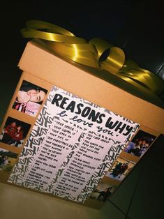 a cardboard box with some pictures on it and a yellow ribbon tied around the top