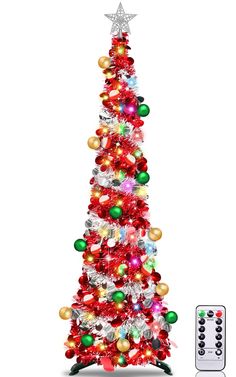 a christmas tree with lights and ornaments next to a remote control on a white background