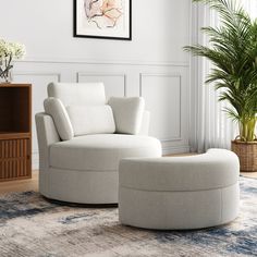 a white chair and ottoman in a room with a potted plant on the floor