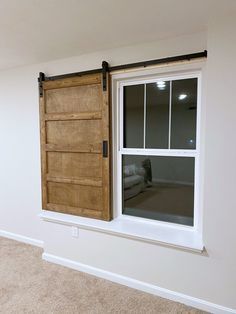 an empty room with a sliding door and window in the center, next to a carpeted floor