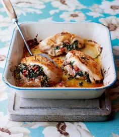 chicken with spinach and cheese in a white dish