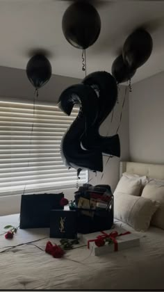 some balloons are hanging from the ceiling above a bed