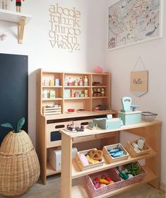 a child's play room with toys on the table and shelves in front of it