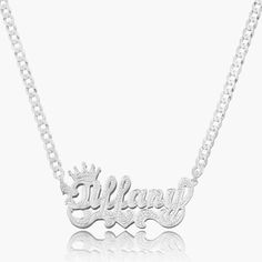 Our popular Double Plated Iced Princess Crown Name Necklace boasts a chic and elegant design, handcrafted to perfection. The model showcases the necklace with an 18-inch Cuban chain (see video for reference). You can personalize this item with Letters, Numbers, and Roman Numerals and choose from chain lengths of 14", 16", 18", and 20". Each chain features a lobster clasp closure for secure wear.Chain width:Cuban Chain - 3.7 mmFigaro Chain - 3 mmRope Chain - 2.3 mm XO Chain - 5 mm Xo Chain, Numbers Roman Numerals, Name Necklace Silver, Dainty Initial Necklace, Ring Bracelet Chain, Crown Necklace, Name Earrings, Engraved Pendant, Ice Princess