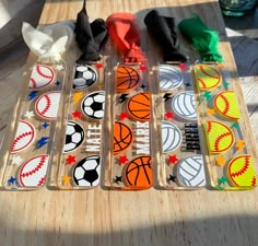 several different colored sports themed items on a wooden table next to plastic bags and napkins