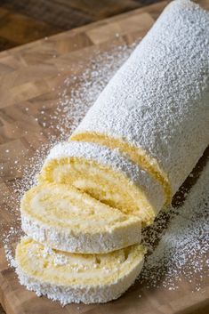 some type of bread on a cutting board with sugar sprinkles around it