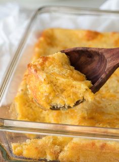 a wooden spoon scooping some food out of a casserole dish