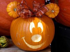 an orange pumpkin with a bow on it's head and the number 51 carved into it