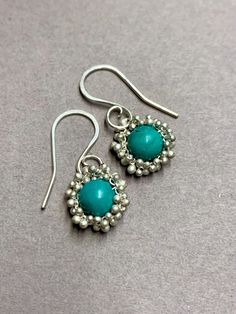 Our 360 Degree Caviar and Turquoise Solitaire Earrings stand out! Our Caviar metalwork (tiny silver balls securely torched into place) in Sterling Silver surrounding these 6mm round turquoise rondels.  These beauties are finely handcrafted and thoughtfully designed to be light.  This fluid movement shows off these classic turquoise earrings.   *Sturdy yet delicate. *Unique metalwork design and craftmanship. *Comfortable with style and grace. * Rubber backs included for you to keep them securely on your ears.  Attention to detail with tiny silver metalwork clustered together of unique "caviar."  Will be cherished for years to come as one of your favorites.  Ear wires are made in Sterling Silver.    Turquoise color is blue/green with matrix.  *Ready to ship! *Workmanship guarantee. *Gift wra Adjustable Hand-tooled Turquoise Jewelry, Traditional Hand-tooled Turquoise Jewelry, Artisan Turquoise Beaded Hand-strung Earrings, Turquoise Sterling Silver Earrings - Fine Jewelry, Earrings Stand, Fluid Movement, Hand-strung Blue Southwestern Jewelry, Solitaire Earrings, Earring Stand