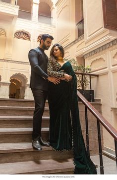 a man and woman standing on some stairs