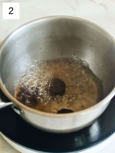 a pot filled with liquid sitting on top of a stove