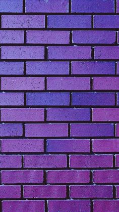 a purple brick wall is shown in close up