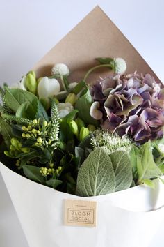 a white vase filled with lots of flowers