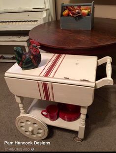 a small table with a red cup on it and a rooster figurine sitting on top