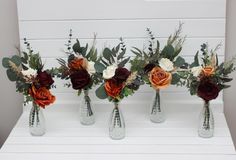 four vases filled with different types of flowers