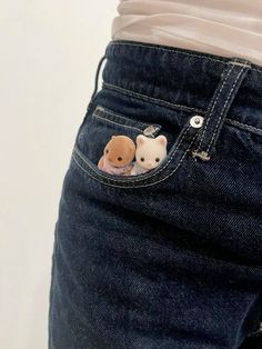 a pair of jeans with two teddy bears in the pocket