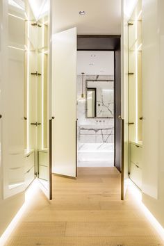 an open door leading to a bathroom with marble walls and flooring in the background