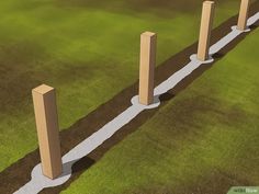 an artist's rendering of three concrete pillars in the grass