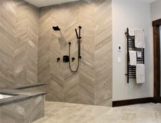 a bathroom with a tub, shower head and towel racks on the wall next to it