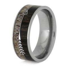 a wedding ring with an arrow in the center and antelope wood inlay