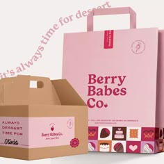 a pink box with the words berry babes co written on it next to an open cardboard box