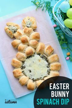 an easter bunny spinach dip is shown on a napkin next to some buns