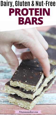 chocolate peanut butter protein bars stacked on top of each other with text overlay reading dairy, gluten & nut - free protein bars