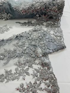 an image of a wedding dress with silver sequins and beads on the fabric