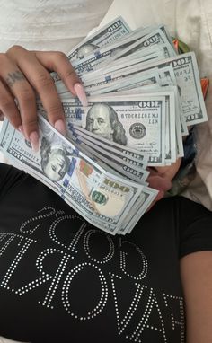 a woman is holding money in her lap