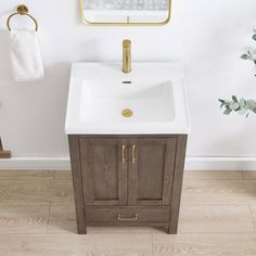 a white sink sitting under a mirror next to a wooden cabinet